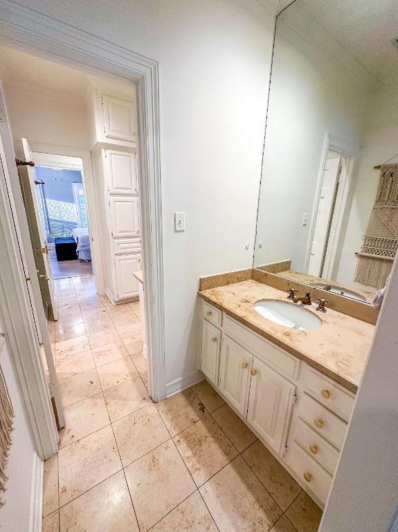 bathroom with baseboards, vanity, and tile patterned floors