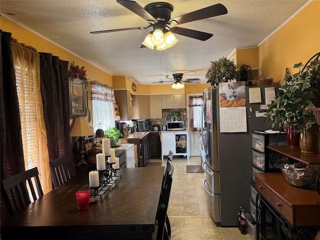 1804 Davis St, Taylor, TX 76574 - dining room with ceiling fan, a textured ceiling, ornamental molding, and light flooring