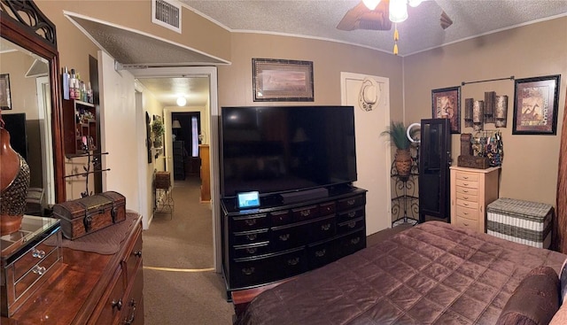 bedroom featuring visible vents, ceiling fan, crown molding, a textured ceiling, and carpet floors