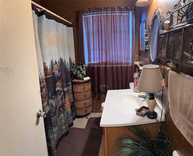 full bath featuring vanity, a shower with shower curtain, and tile patterned floors