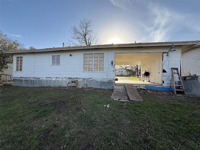 1804 Davis St, Taylor, TX 76574 - rear view of property featuring a lawn and an attached carport