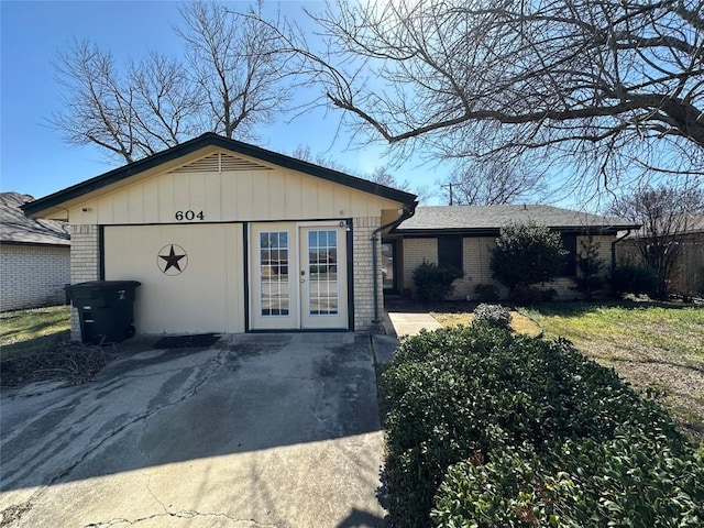 view of front of home featuring french doors and brick siding