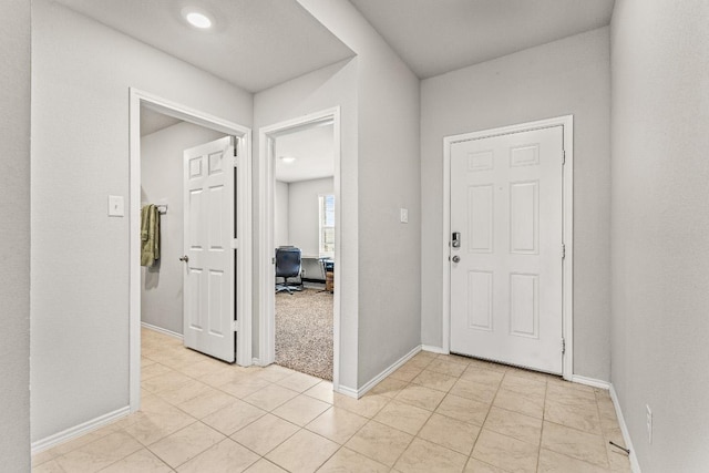 entrance foyer featuring baseboards and light tile patterned floors