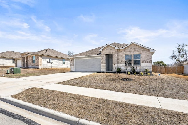 single story home with an attached garage, fence, driveway, stone siding, and roof with shingles