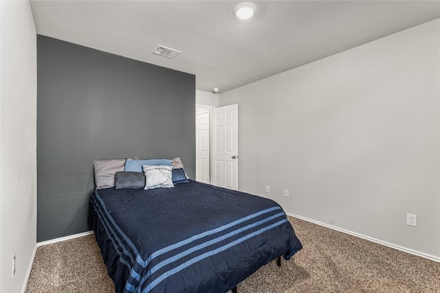 carpeted bedroom with baseboards and visible vents