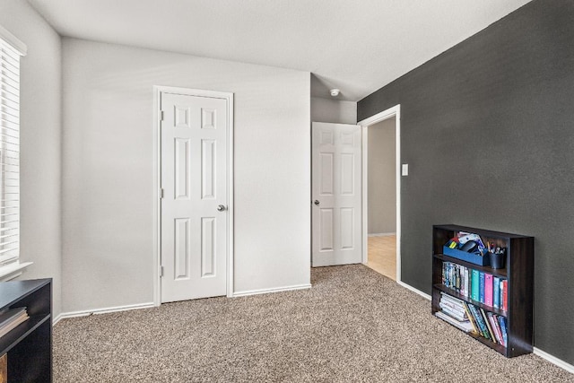 carpeted bedroom featuring baseboards