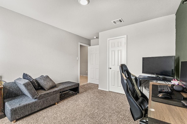 carpeted office space with visible vents and baseboards