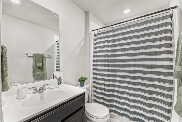 bathroom featuring a shower with curtain, vanity, and toilet