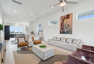 living room featuring a healthy amount of sunlight, visible vents, a ceiling fan, and recessed lighting