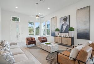 living area with a ceiling fan and recessed lighting