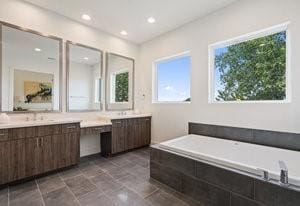 full bath with a garden tub, recessed lighting, and vanity