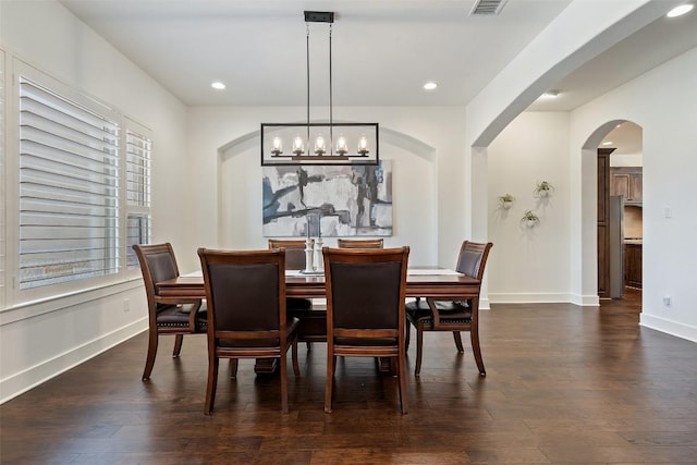 dining room featuring recessed lighting, baseboards, dark wood-type flooring, and arched walkways