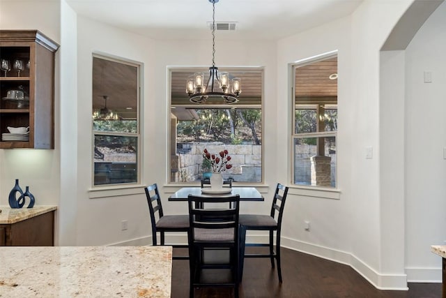 dining space with visible vents, arched walkways, baseboards, and dark wood-style floors