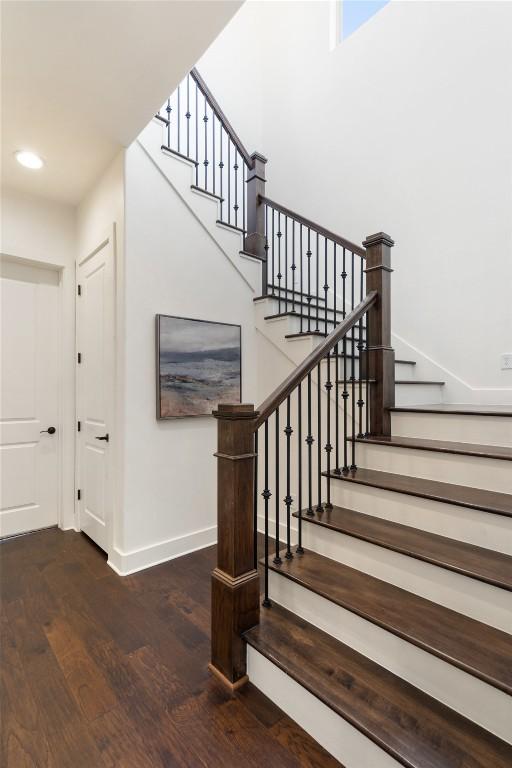 stairs with recessed lighting, wood finished floors, and baseboards