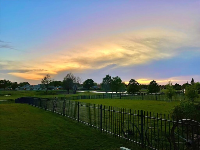 view of yard with a rural view and a fenced backyard