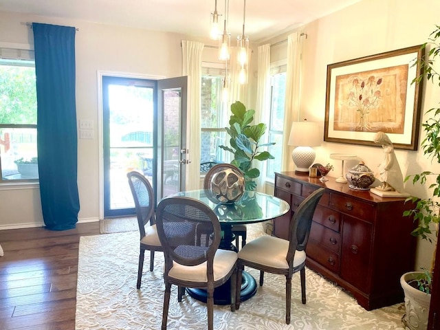 dining room featuring light wood finished floors and baseboards