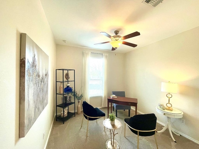 living area with baseboards, ceiling fan, visible vents, and carpet flooring