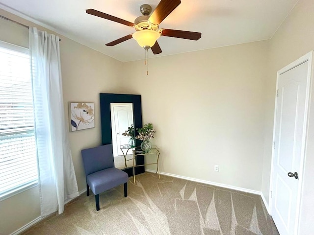 sitting room with baseboards, carpet flooring, and a healthy amount of sunlight