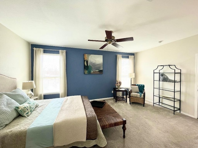 bedroom with a ceiling fan, carpet flooring, and baseboards