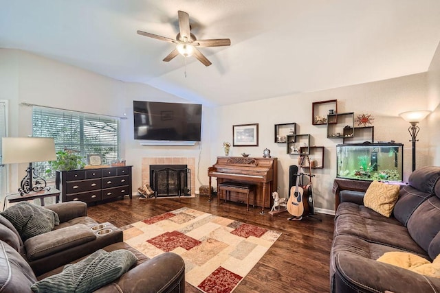 living area with a fireplace, wood finished floors, a ceiling fan, baseboards, and vaulted ceiling