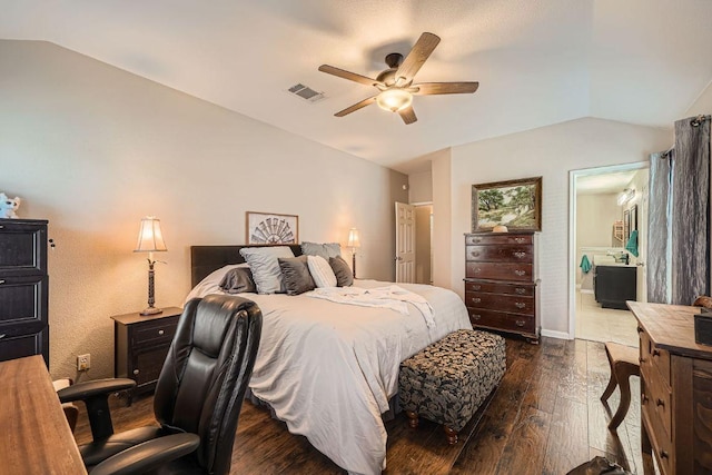 bedroom with lofted ceiling, visible vents, ensuite bathroom, dark wood-type flooring, and a ceiling fan