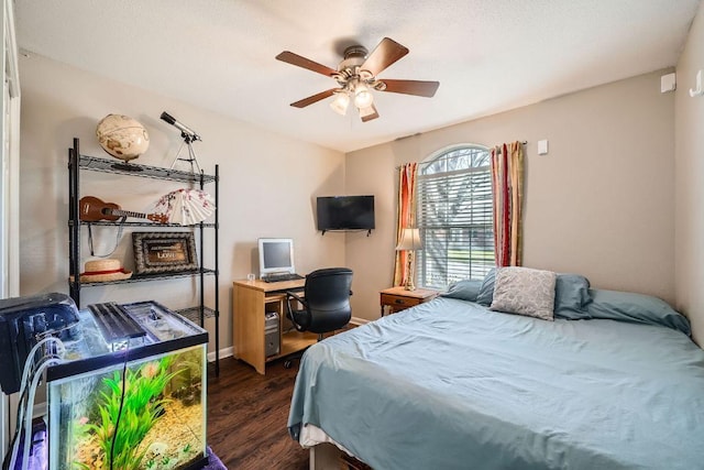 bedroom with dark wood-style flooring, ceiling fan, and baseboards