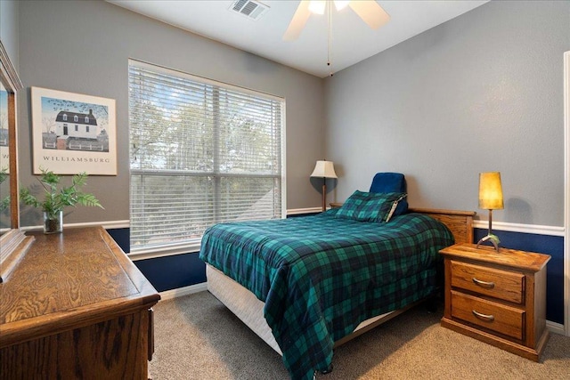 bedroom with visible vents, light carpet, and baseboards