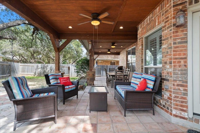 view of patio with ceiling fan, an outdoor hangout area, and fence