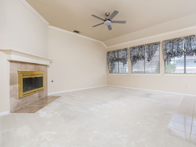 unfurnished living room featuring a tile fireplace, carpet floors, visible vents, baseboards, and crown molding