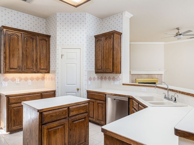 kitchen featuring light tile patterned floors, a sink, light countertops, dishwasher, and wallpapered walls