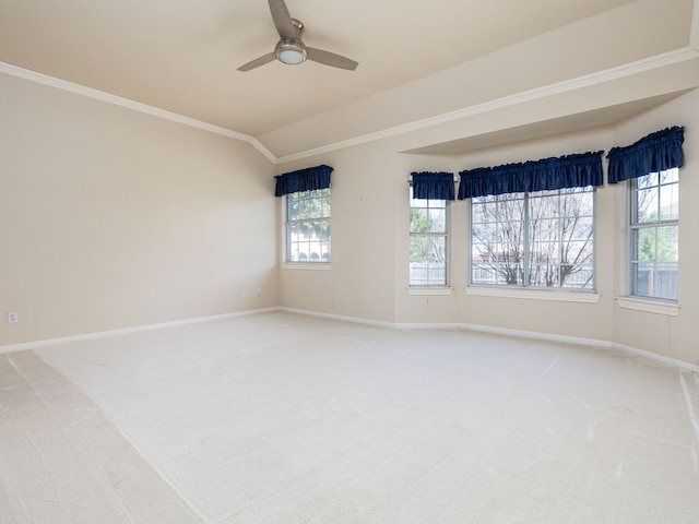 spare room featuring ornamental molding, light colored carpet, and baseboards