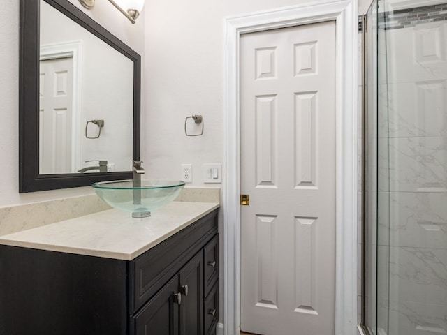 bathroom featuring vanity and an enclosed shower