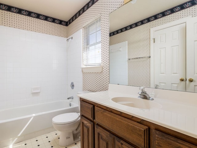 bathroom with toilet, wallpapered walls, shower / bath combination, and vanity