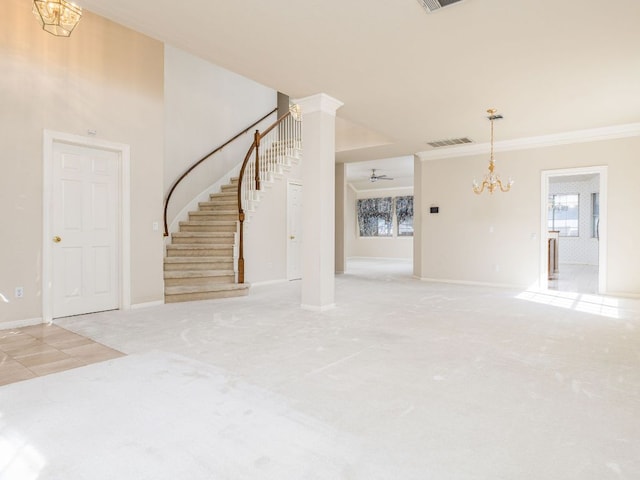 interior space featuring stairway, visible vents, crown molding, and ceiling fan with notable chandelier