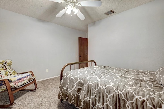 bedroom featuring a textured ceiling, ceiling fan, visible vents, baseboards, and carpet