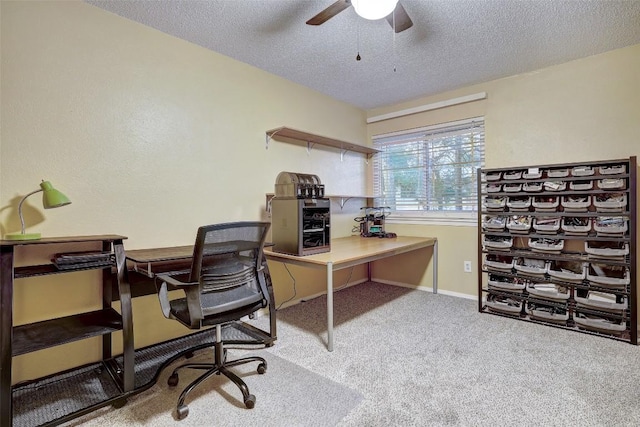 carpeted office space featuring a ceiling fan, a textured ceiling, and baseboards