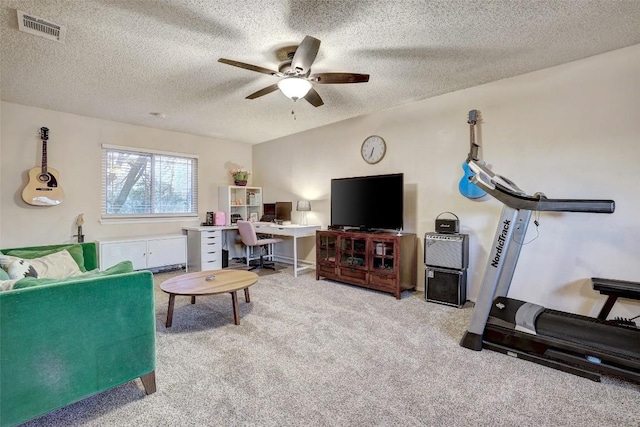 living room with light carpet, ceiling fan, visible vents, and a textured ceiling