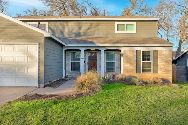 view of front of house featuring a garage, brick siding, and a front lawn