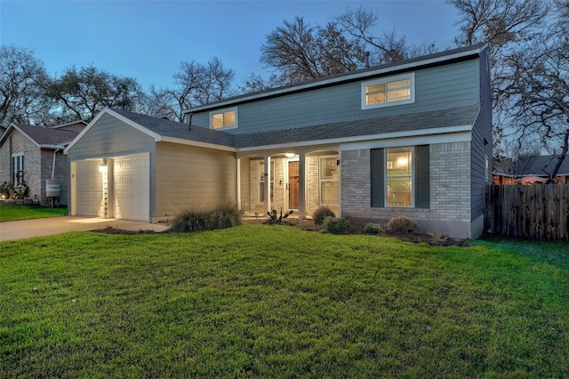 traditional-style home featuring a front yard, brick siding, fence, and an attached garage