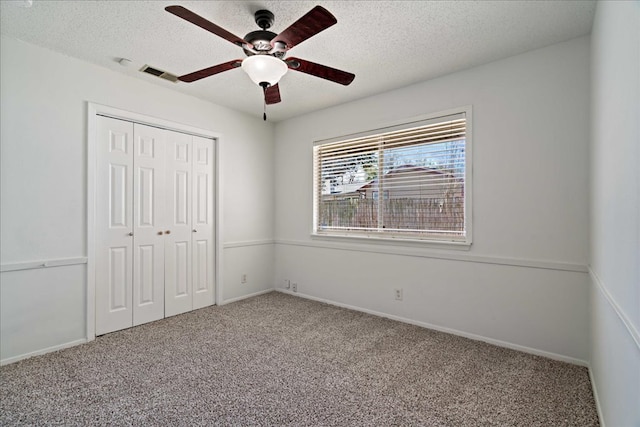 12306 Hickorystick Cv, Austin, TX 78750 - unfurnished bedroom with carpet floors, a closet, a textured ceiling, and visible vents