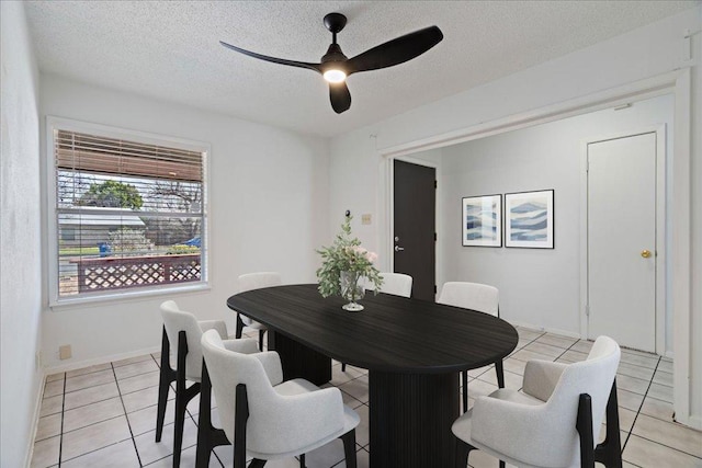 12306 Hickorystick Cv, Austin, TX 78750 - dining room featuring baseboards, a ceiling fan, a textured ceiling, and light tile patterned floors