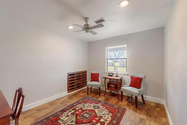 living area with visible vents, ceiling fan, baseboards, recessed lighting, and wood finished floors