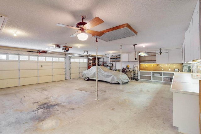 garage with a garage door opener and a ceiling fan