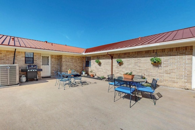 view of patio / terrace with outdoor dining area, area for grilling, and central AC