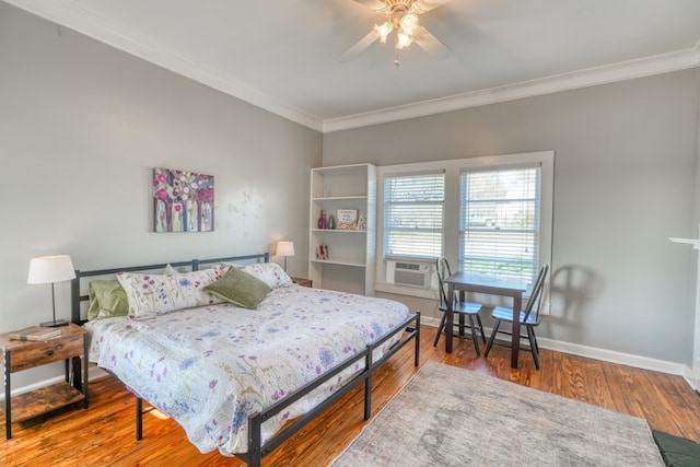 bedroom with ornamental molding, ceiling fan, wood finished floors, cooling unit, and baseboards