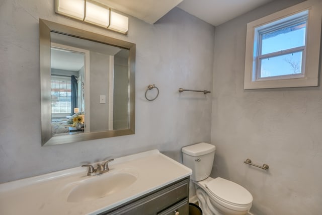 half bathroom with toilet and vanity