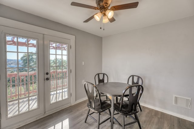 dining room featuring baseboards, visible vents, a ceiling fan, wood finished floors, and french doors