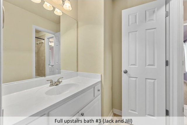 full bathroom featuring baseboards, a chandelier, and vanity