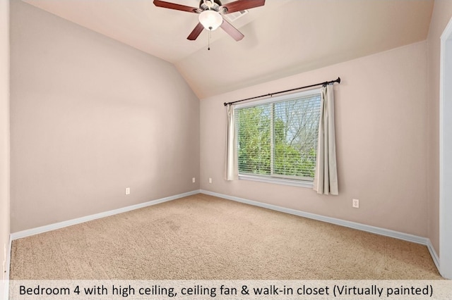 carpeted spare room featuring ceiling fan, baseboards, and vaulted ceiling