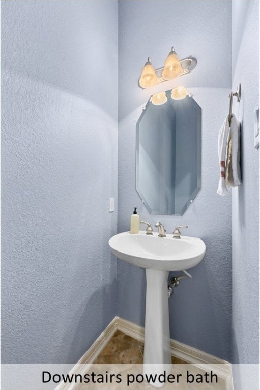 bathroom featuring tile patterned flooring and baseboards